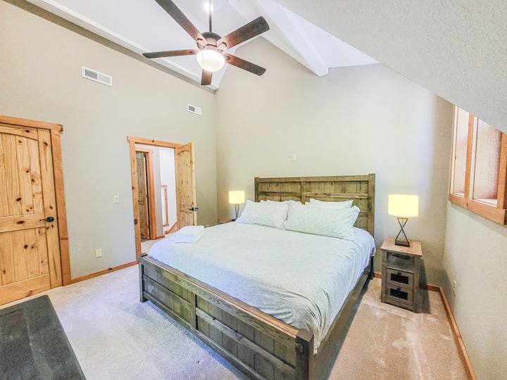 Upstairs king bed with views of the creek and lush green forest right outside your windows.