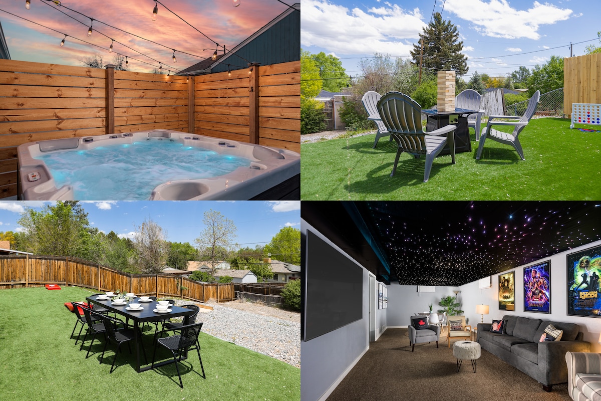 The image showcases a well-maintained outdoor space featuring a hot tub and a fire pit surrounded by lounge chairs. Twinkling string lights add ambiance above the seating area, while green grass fills the yard, creating a welcoming environment for relaxation and gatherings.