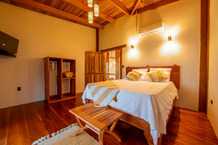 Queen bedroom with private bathroom and air conditioning.