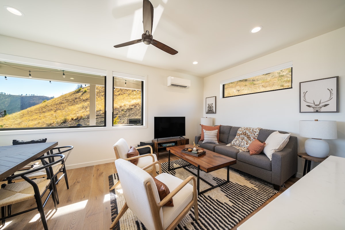 Cozy living area with panoramic hillside views—featuring a pullout sofa bed for extra guests or spontaneous naps