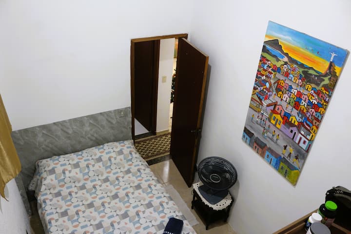 Room with a double bed, powerful fan and large wardrobe. Fresh and ventilated room.