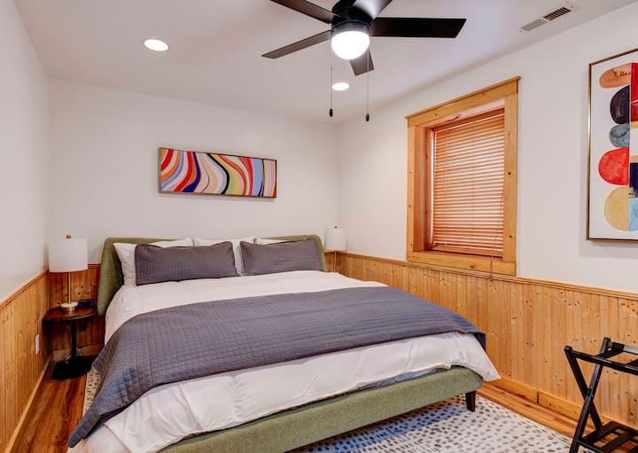 Bedroom 4 is downstairs and has a comfortable and colorful feel with a king bed. 
