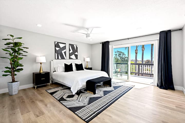 Spacious Master Bedroom with king bed, 2 closets, TV, attached private bathroom with quartz counters & view deck for morning coffee or a treat!