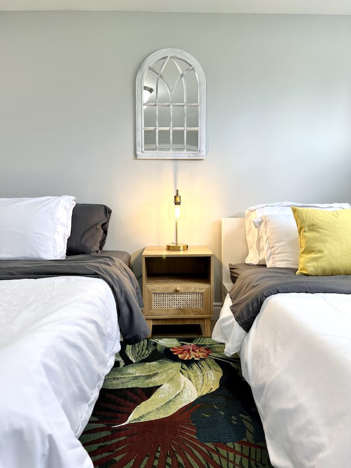 This cozy bedroom features two comfortable beds, making it perfect for families or friends traveling together. The inviting decor creates a warm atmosphere, ensuring restful nights and a relaxing retreat after a day of adventures.