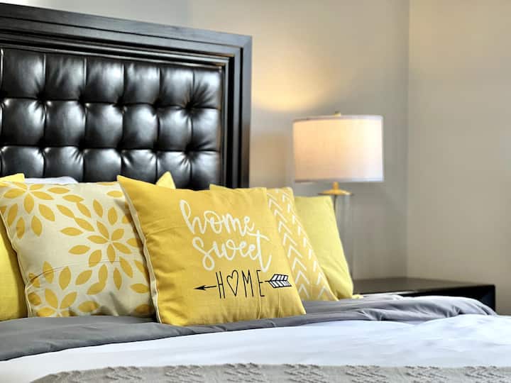 A cozy and inviting bedroom featuring a comfortable bed, warm lighting, and tasteful decor. This space is designed for relaxation, providing a perfect retreat for restful nights.
