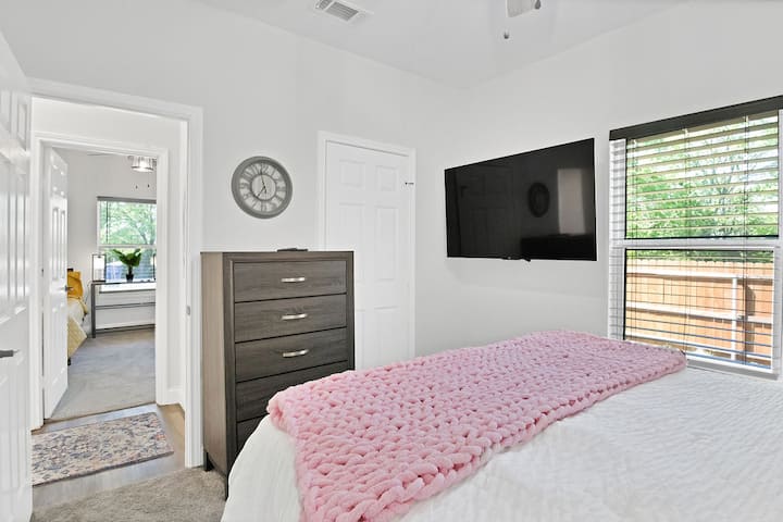 Bedroom 2 is furnished with a queen size bed, 5-drawer dresser and has a closet — keeping the room tidy and organized. Additionally, this room has its own 55" smart TV allowing you to enjoy your favorite shows  right from the comfort of the bed. 