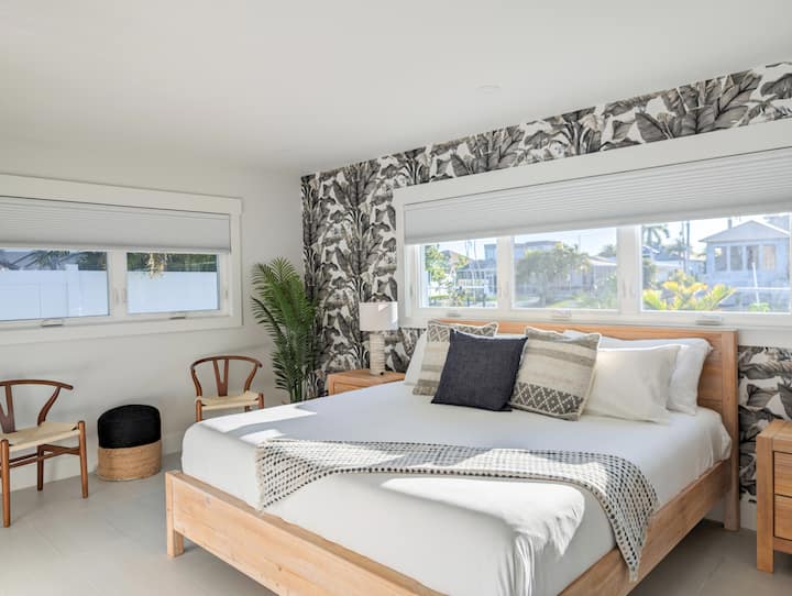 Primary ensuite bedroom with private bathroom, TV,  and walk-in closet with security safe