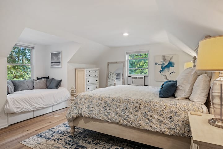 This bedroom is all about style and comfort. The perfect bed setup with soft pillows and a chic rug.