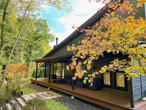 Karuizawa villa with a stream flowing through it