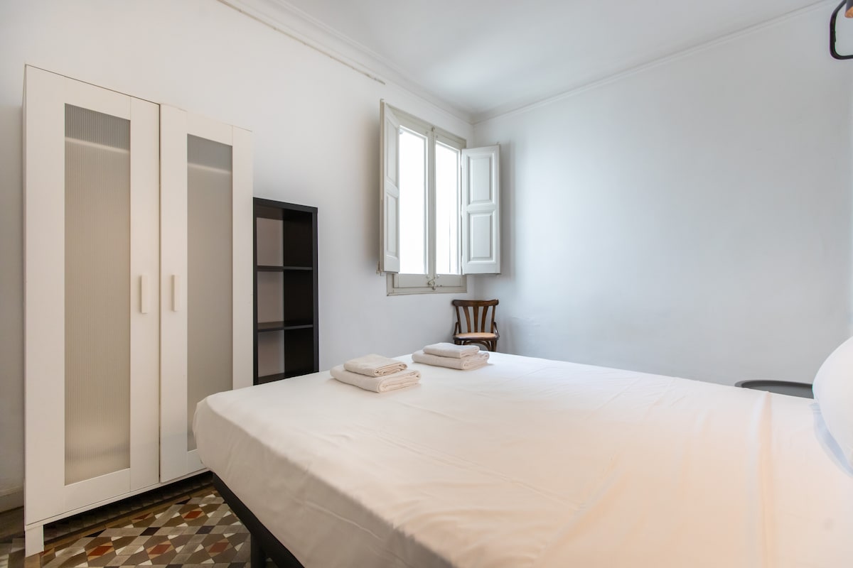 חדר שינה עם מיטה זוגית וארון.