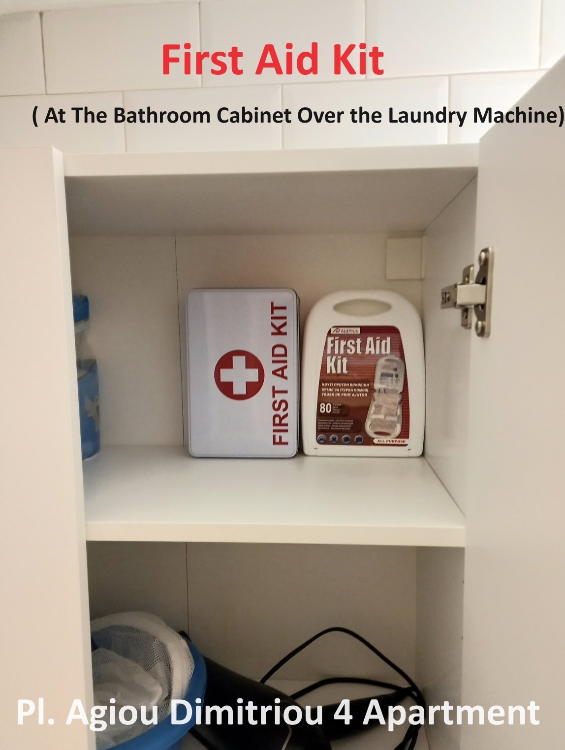 A bathroom cabinet is shown, positioned above the laundry machine. Inside, a first aid kit with a prominent red cross symbol is displayed alongside a blue bottle. The space is well-organized, ensuring key essentials are easily accessible.