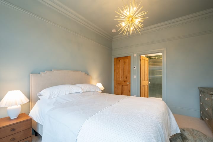 Painted in soft blue hues and flooded with natural light, Bedroom 1 is truly serene. Benefitting from an ensuite bathroom