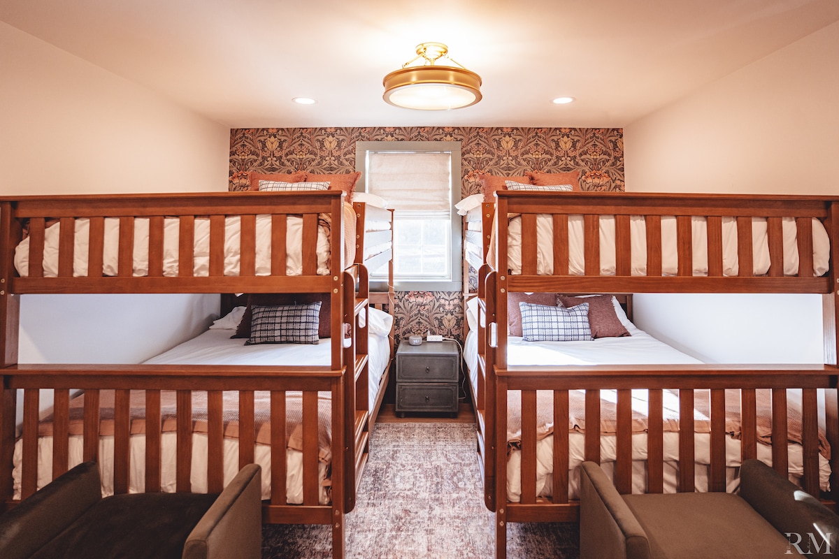 Bedroom 2 has two sets of full size bunk beds, blackout blinds, full size mirror, hangers in the closet, alarm clock and sound machine and a charging station on the nightstand. 