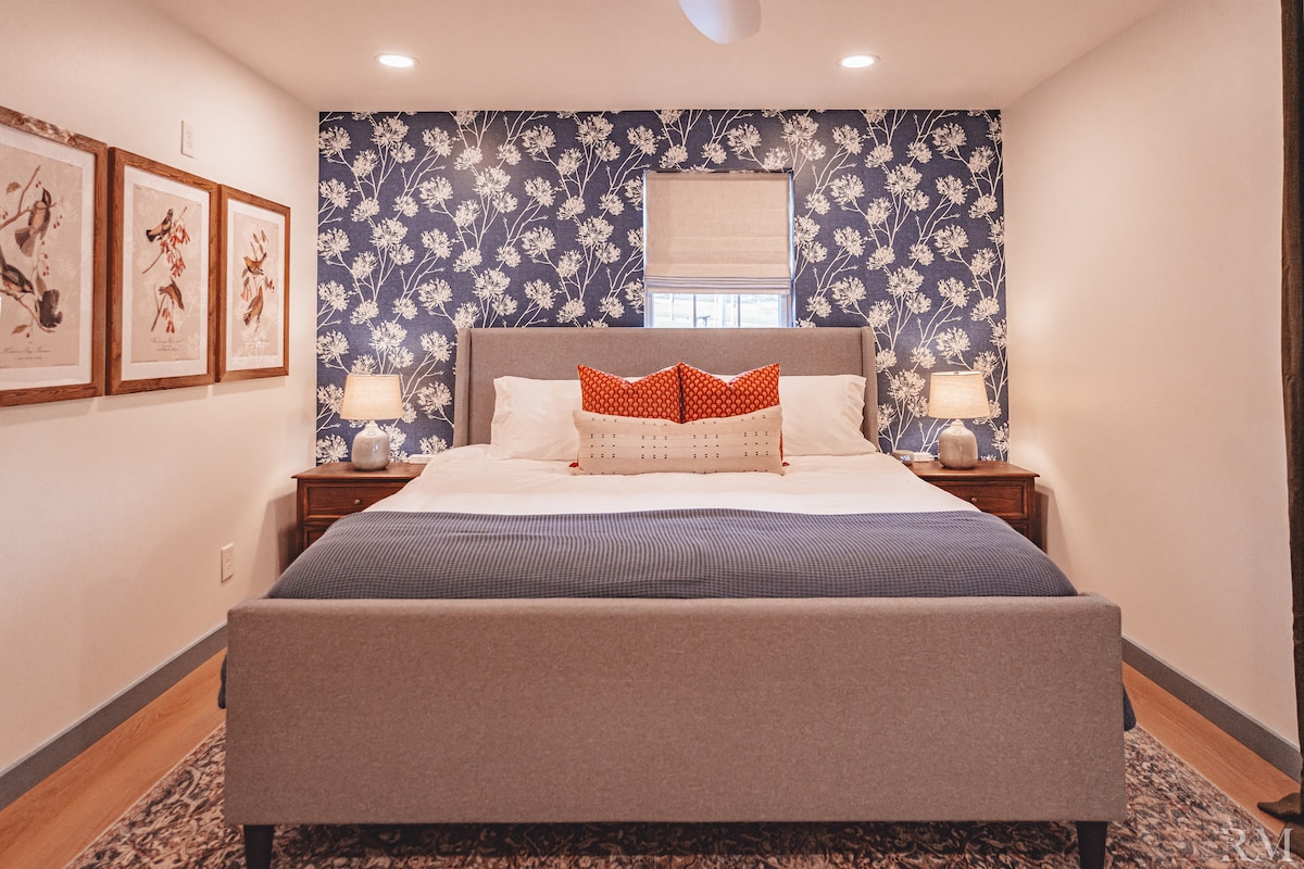The main bedroom combines comfort and convenience, creating a welcoming and practical space for guests to relax and enjoy their stay. This bedroom is equipped with a king size bed with charging stations on each nightstand.