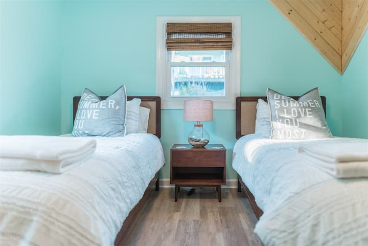 Bedroom 4 features two twin beds and a reading nook.