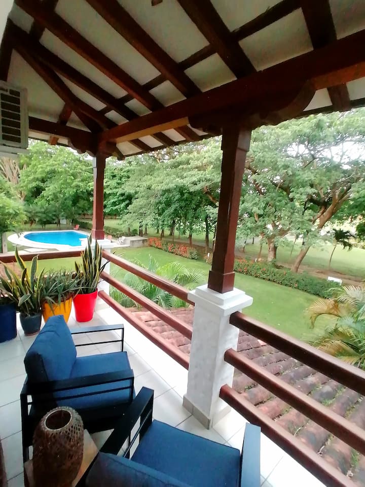 Private porch off master bedroom with comfortable reading chairs and a beautiful view of the manicured golf course.