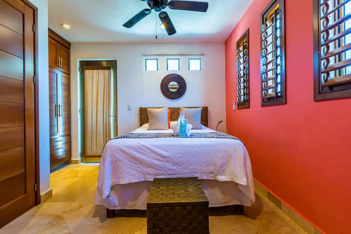 Casita A Pink Room Queen Bed back patio view of Pool and Gardens