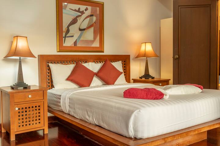 Descansa en la cama tamaño queen con sábanas suaves. Disfruta del aire acondicionado, el almacenamiento de ropa y las persianas que oscurecen la habitación. Una puerta corrediza de vidrio ofrece una vista impresionante de la piscina, mezclando comodidad con elegancia.