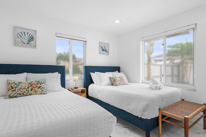 Two full beds with a Smart TV