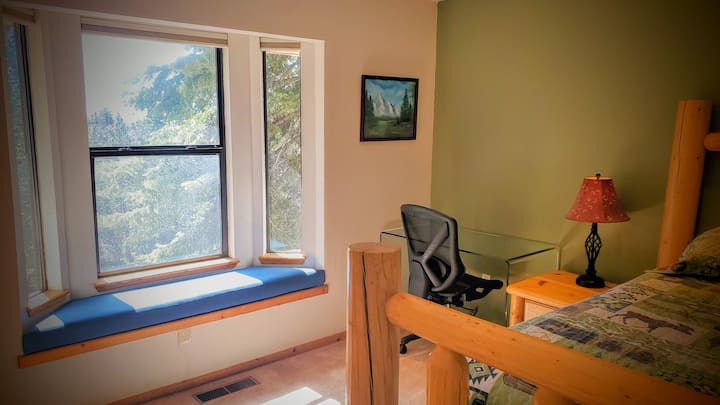 Master Suite 1 Has a Dedicated Workspace with Glass Desk and Fully Adjustable Rolling Webbed Fabric Office Chair, Private Ensuite Full Bath, and Bay Windows Overlook Several Mountain Ranges and National Forest.