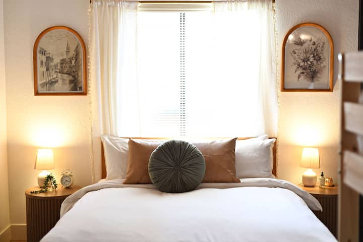 Cozy loft bedroom tucked in the far corner for added privacy, featuring a queen-sized bed and nightstands—your peaceful retreat in the heart of the home