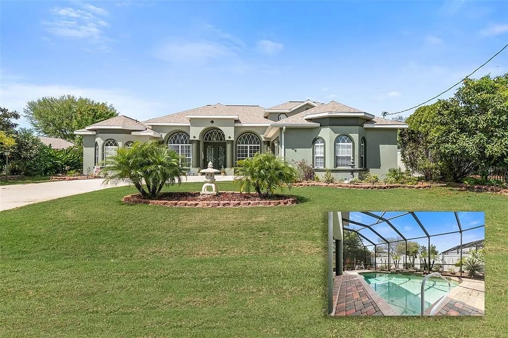 The exterior of a spacious four-bedroom home is presented, featuring a manicured lawn and inviting landscaping. The architectural design includes arched windows and a light green facade, set under a clear blue sky, creating a welcoming atmosphere for guests.