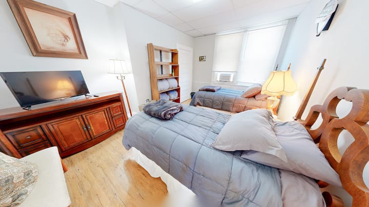 The second bedroom is perfect for the kiddos with AC, flat screen TV, hotel luxury bedding, EXTRA bedding, upholstered settee & pillow, vintage wooden dresser, nightstand, bed frames, and bed steps, with a closet & lots of shelf & hanging space!