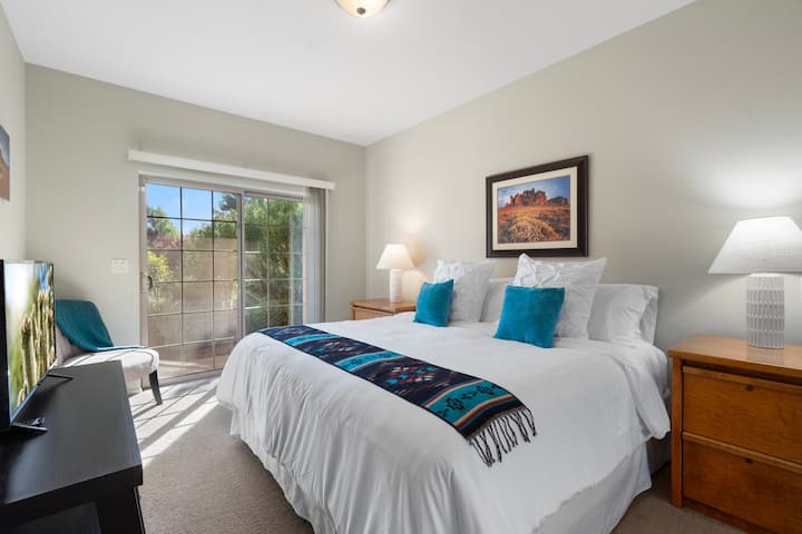 King size bed in the first downstairs guest room. Room includes a smart TV, two nightstands, and a full-size closet for all of your guest's belongings. 