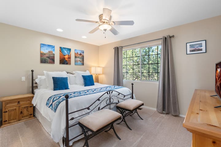 King bed in the primary bedroom upstairs with dresser and two nightstands for storage. Primary bedroom includes ensuite bath with two vanities, stand-up shower and walk-in closet. Red Rock, Hiking, Mountain Biking, Trails, Vortex, Views, Condo