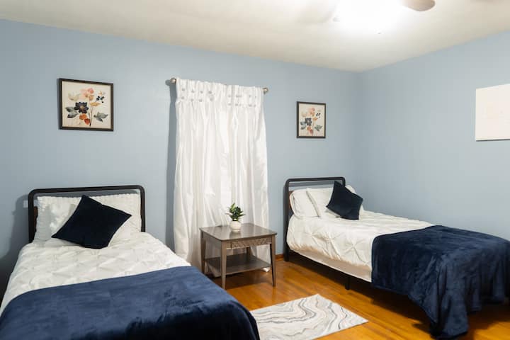 Comfortable Twin Beds: The second bedroom boasts two cozy twin beds, ideal for extra guests or kids. With playful decor and a welcoming atmosphere, it’s perfect for your stay near Indiana University or local attractions.