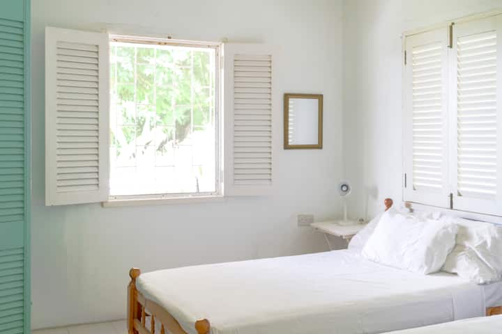 Bedroom #1 in Upper Apartment feature two twin beds that can easily convert into a King with a plush 4” gel & copper-infused topper, just let us know! Mosquito nets available by request.  Screened windows, ceiling and pedestal fans. 