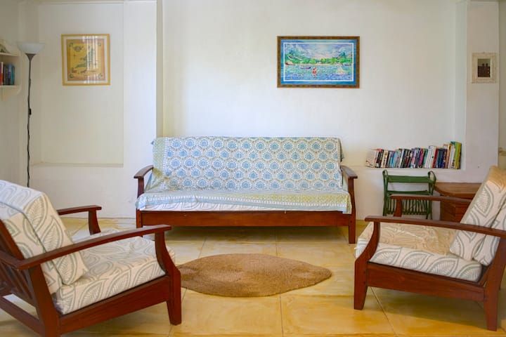 Bright, open living space with a collection of vintage Caribbean books, local artwork and some of our favourite beach games. Now featuring a 32" Fire Smart TV with Netflix, Prime, and YouTube for cozy nights in. 