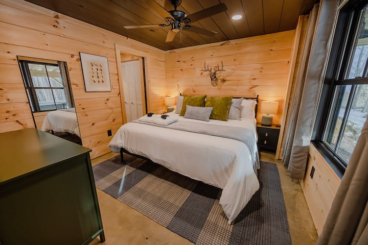 Bedroom #3- Comfy King Bed with en-suite bathroom, Black Out Curtains, Ceiling fan, Dresser, 50 inch smart TV.   Located on the lower level.