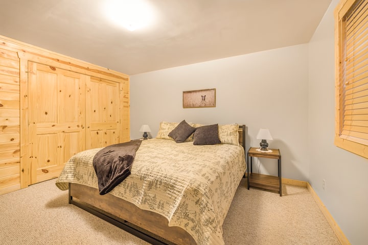A bedroom is equipped with a king bed. 