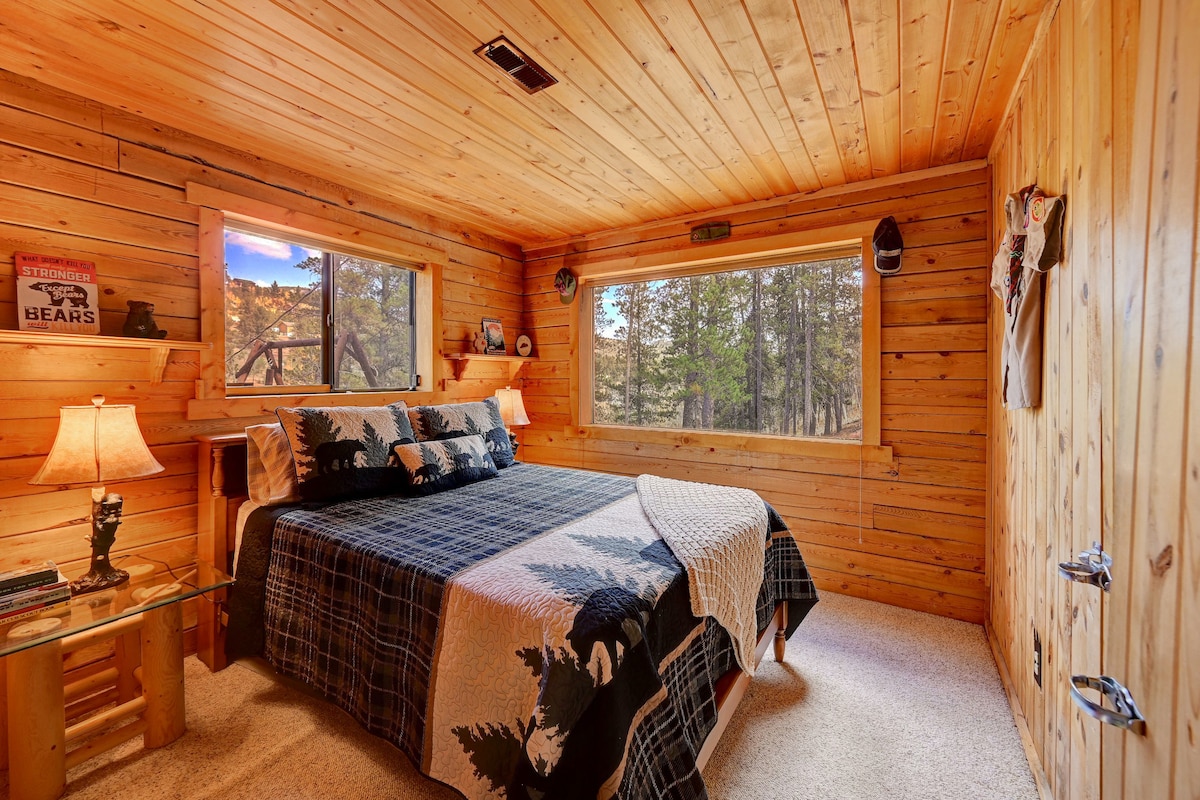 Cozy comfort meets rustic charm in this inviting bedroom retreat. Here's our bedroom with a peaceful views of the surrounding trees and mountains.