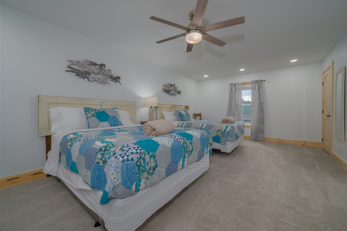 Bedroom #5 This charming country/horse-inspired bedroom features 2 inviting queen beds with vintage farmhouse doors as unique headboards. Perfect retreat for horse lovers and country enthusiasts. Shares a jack n jill bathroom with bedroom #2.