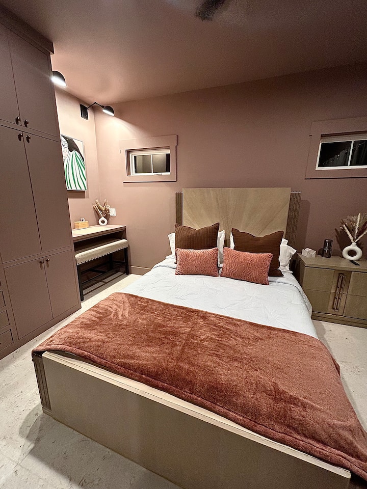 Make yourself right at home in this calming space. The primary bedroom includes a queen bed, built-in custom cabinetry and a designated study/work space.