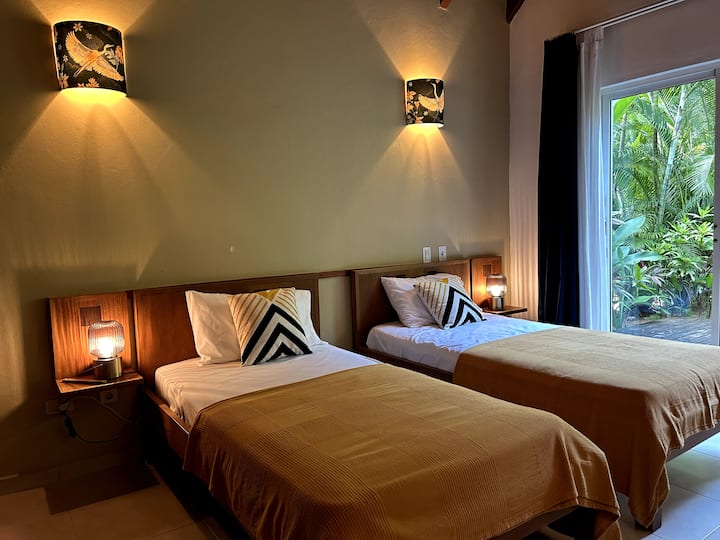 Ground floor room, opening onto the terrace with a half cathedral ceiling, with 2 twin beds and an en-suite bathroom.