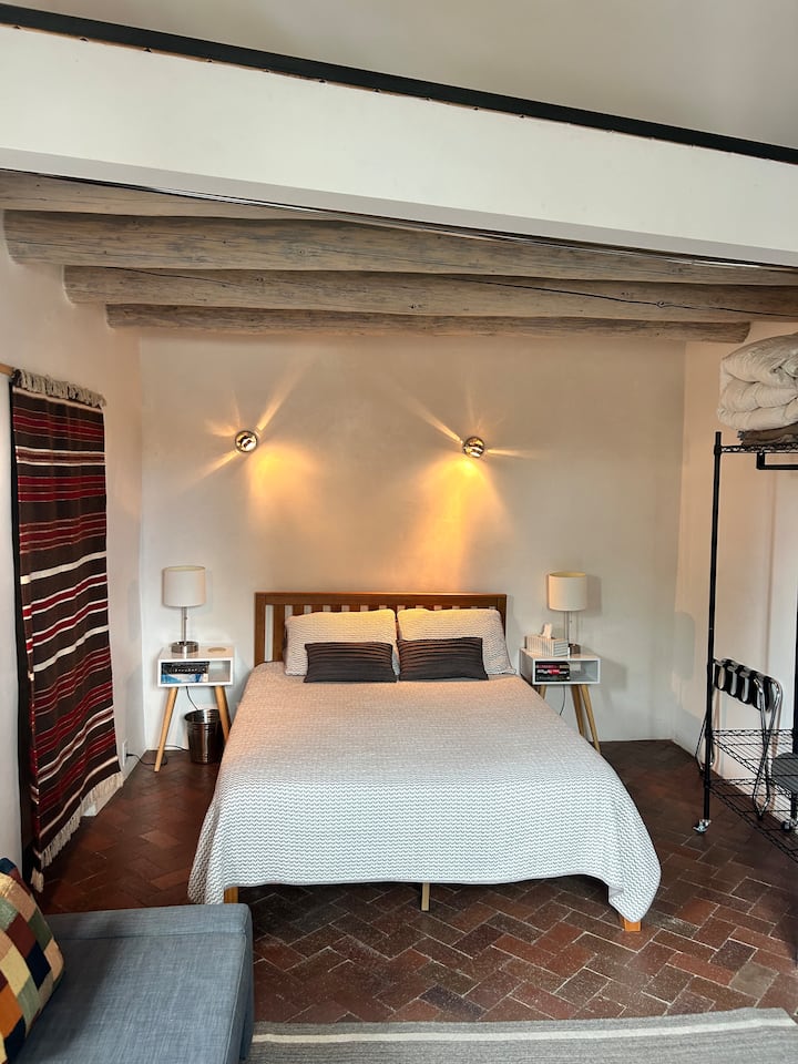 This bedroom is semi-private. There is no door; only curtains divide the space from the living area.