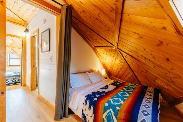 Please note this is a loft bedroom with privacy curtain and 1/2 wall that overlooks the living room.