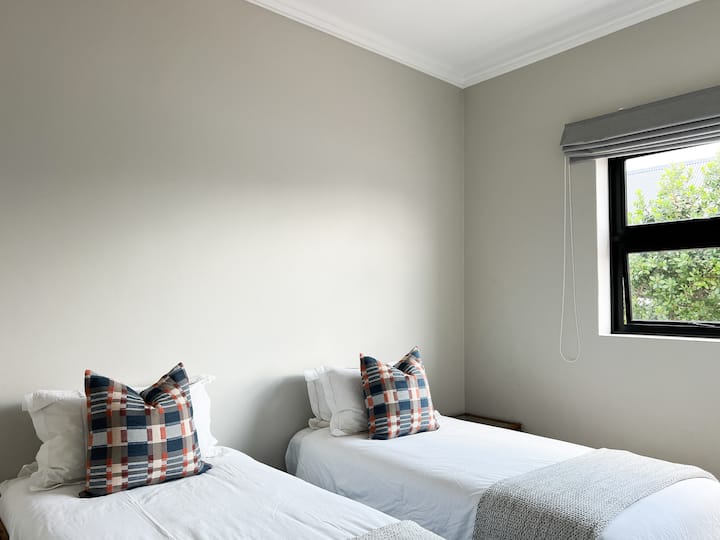 Bedroom 4 has two single beds. The guests have access to a full bathroom immediately adjacent. 