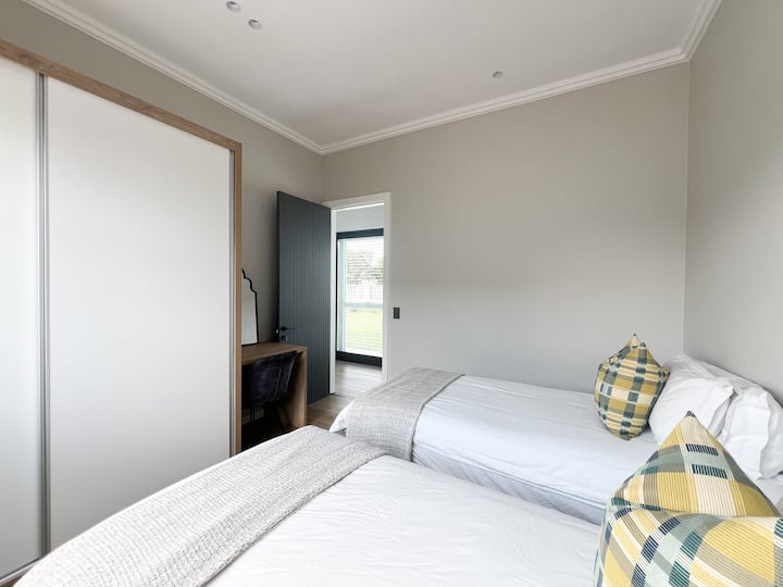 Bedroom 3 has two single beds. The guests have access to a full bathroom immediately adjacent. 