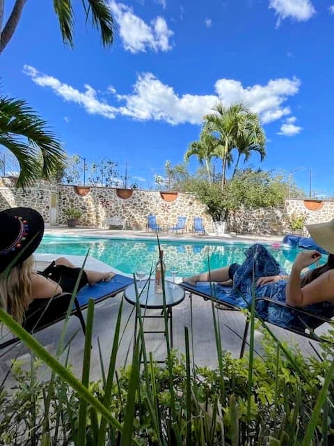 House surrounded by gardens with pool and castle