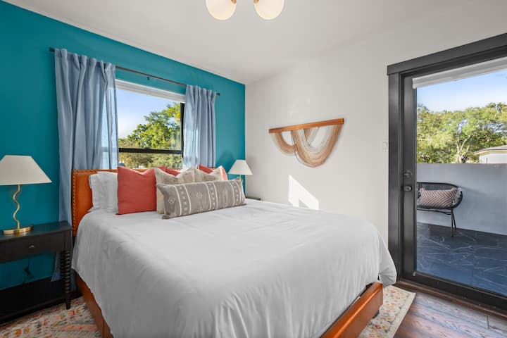 Queen bed with access to the outdoor workout space.