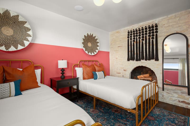 Bedroom with 2 full beds and cozy fireplace.