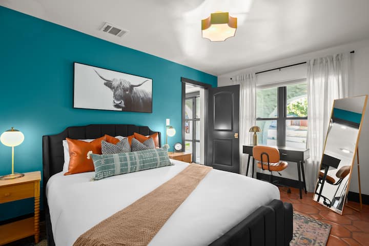 Downstairs queen bed with a desk and private ensuite. 