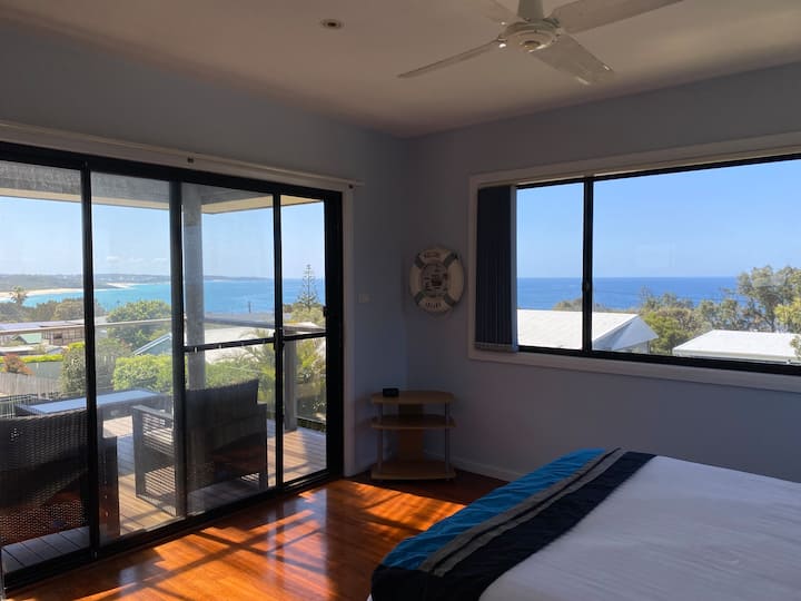 La chambre principale au niveau supérieur offre une vue sensationnelle sur l'océan. Il dispose d'un lit Queen et d'une salle de bains privative, avec une armoire intégrée. Accès direct à la véranda supérieure avec vue imprenable sur la plage et la mer.