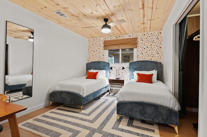 Two cozy twin beds perfect for kids or friends.