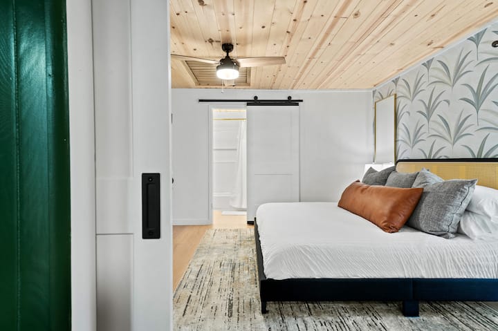 The 4th bedroom offers a king bed and a twin trundle bed, plus an en-suite bathroom.