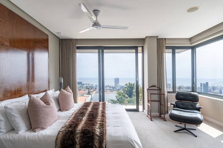 Dhomë gjumi kryesore me dyer të bukura të mëdha rrëshqitëse në një verandë të vogël.